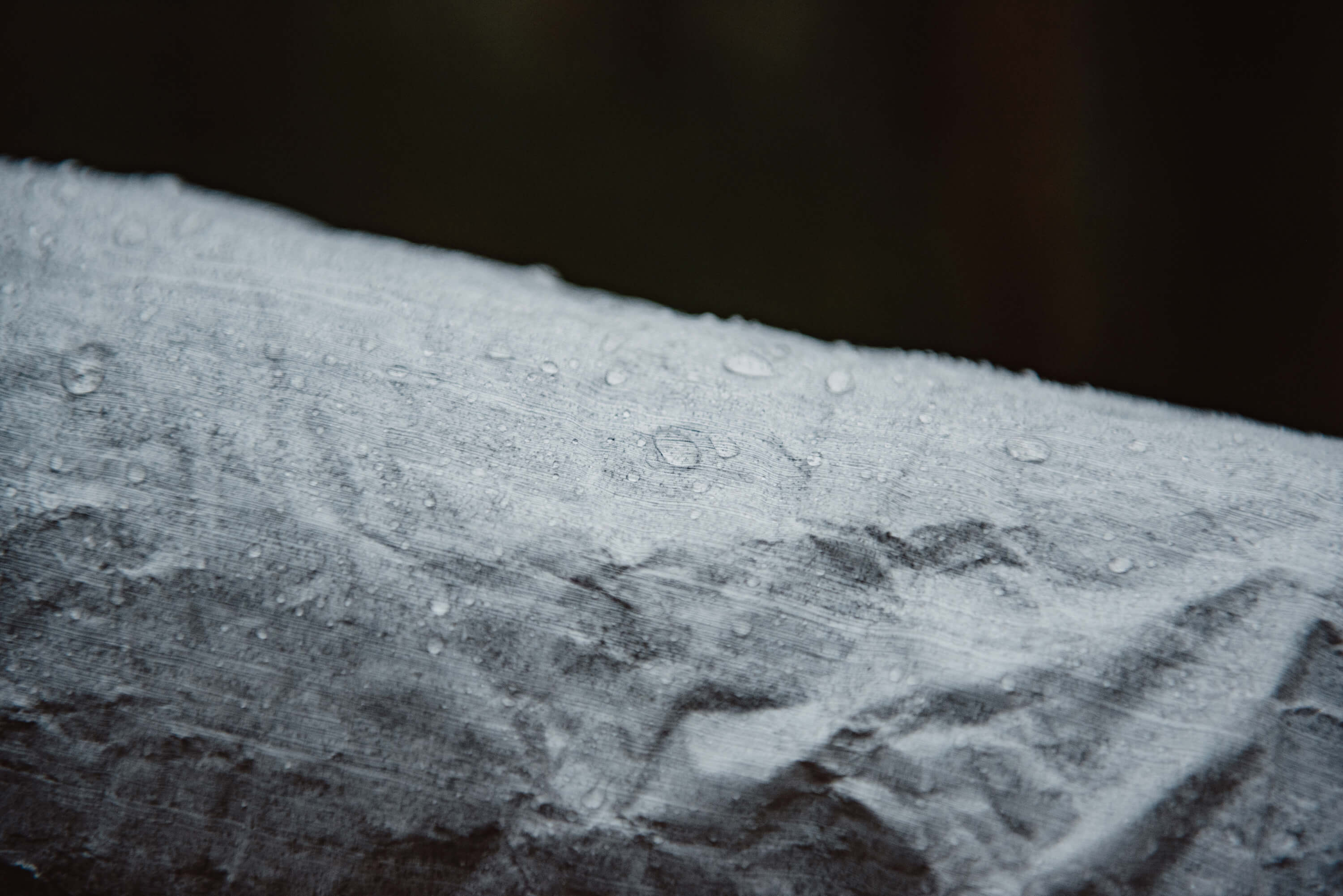 A close up of water droplets on a piece of paper.