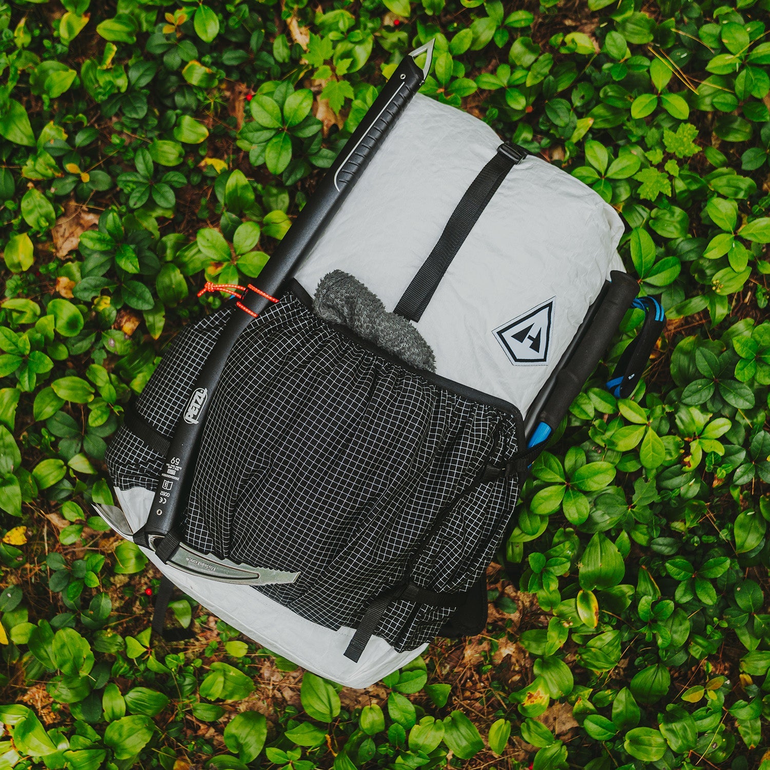 Backpack on a grassy surface with a Hyperlite Mountain Gear brand logo visible