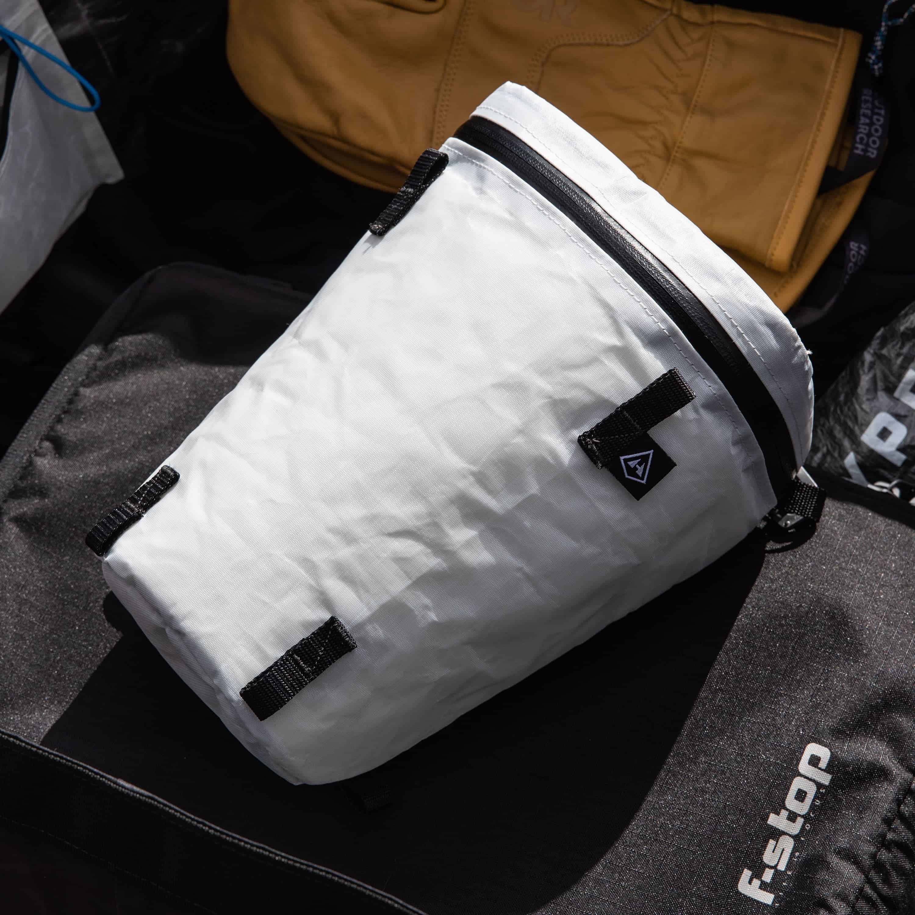 Lifestyle image of the Hyperlite Mountain Gear Camera Pod in White