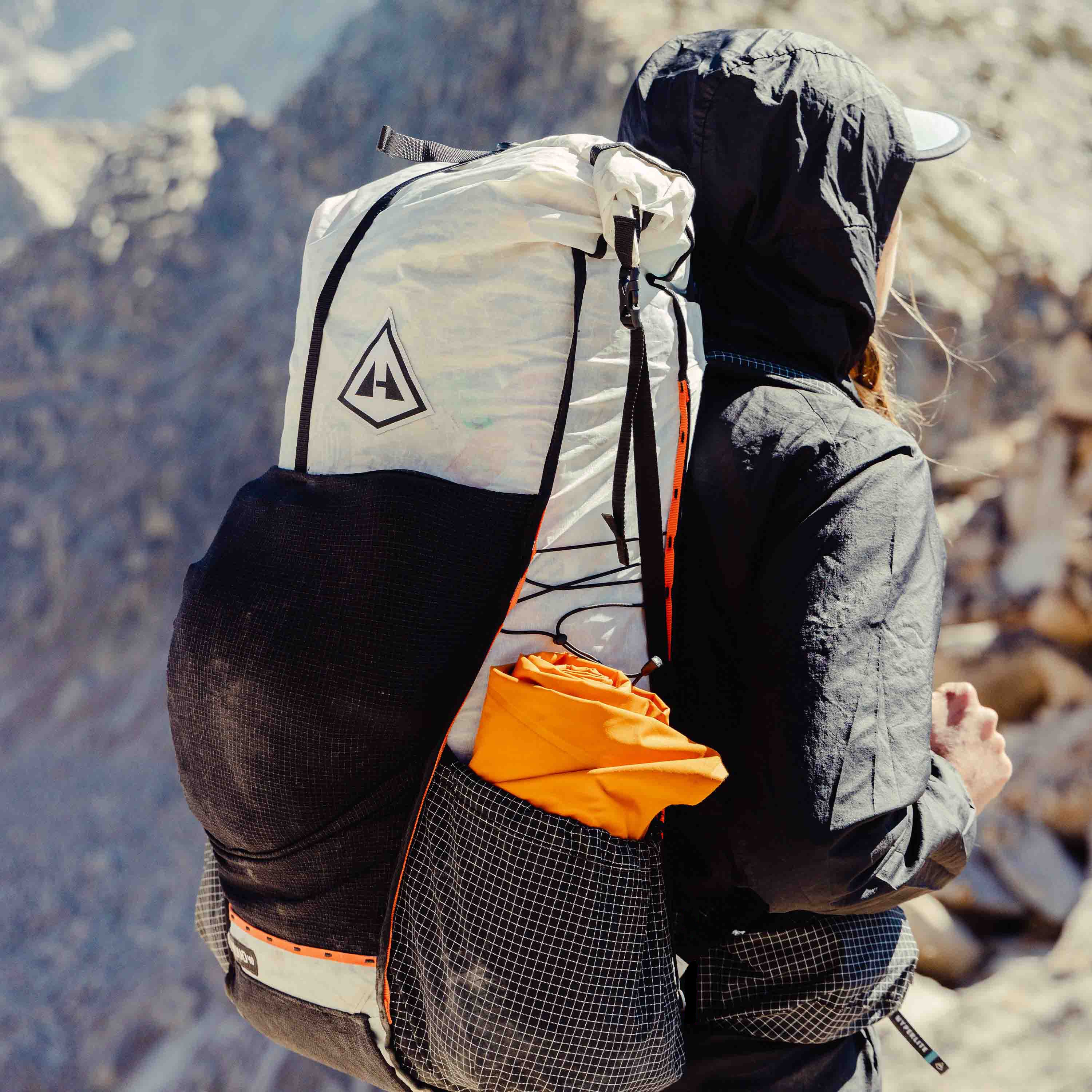 Hiker with a fully packed Hyperlite Mountain Gear Unbound 40 approaches the summit