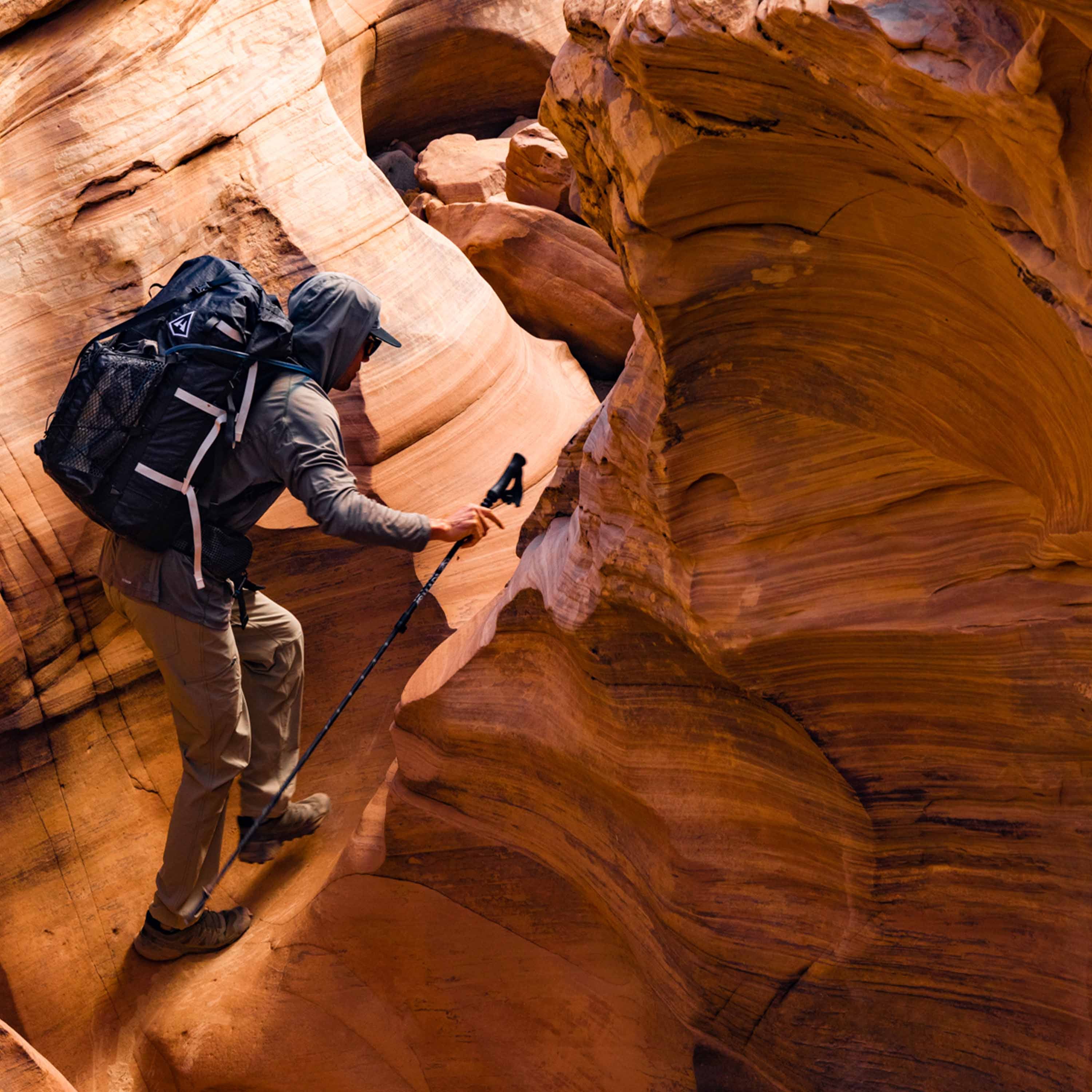 Hiker wearing Hyperlite Mountain Gear's Porter Stuff Pocket in the canyon