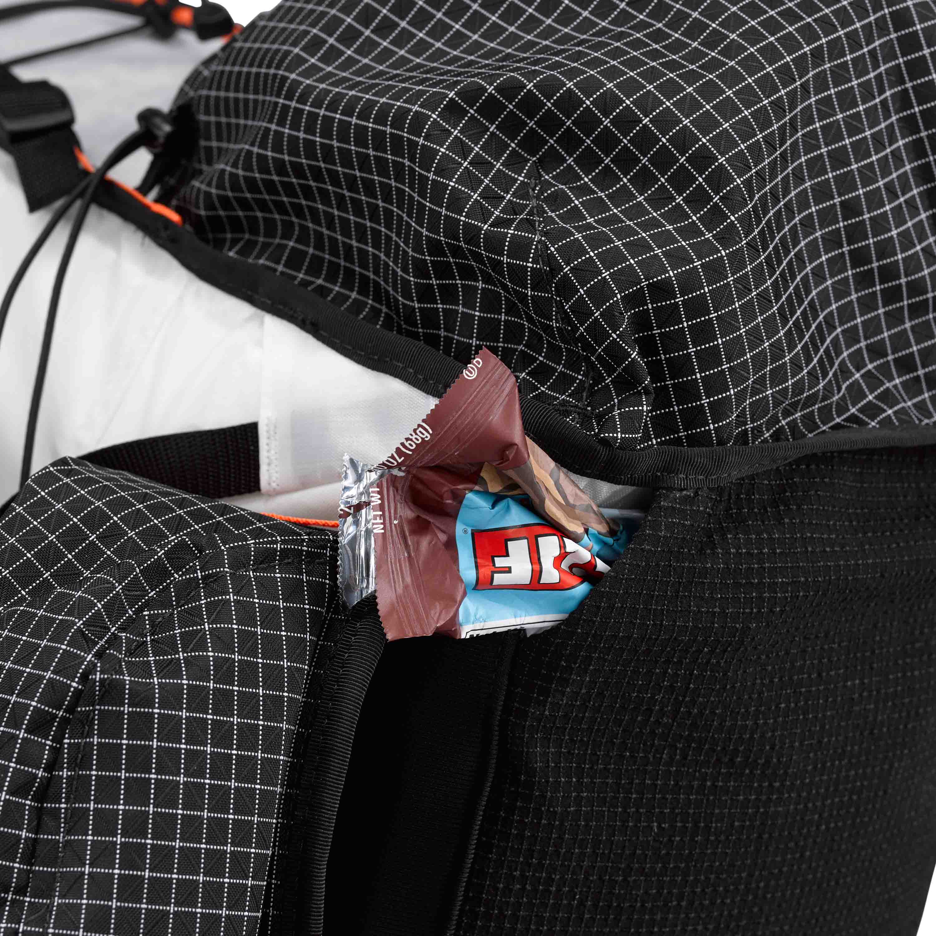 The bottom Dyneema® Stretch Mesh pocket on the Hyperlite Mountain Gear Unbound 40 full of healthy snacks