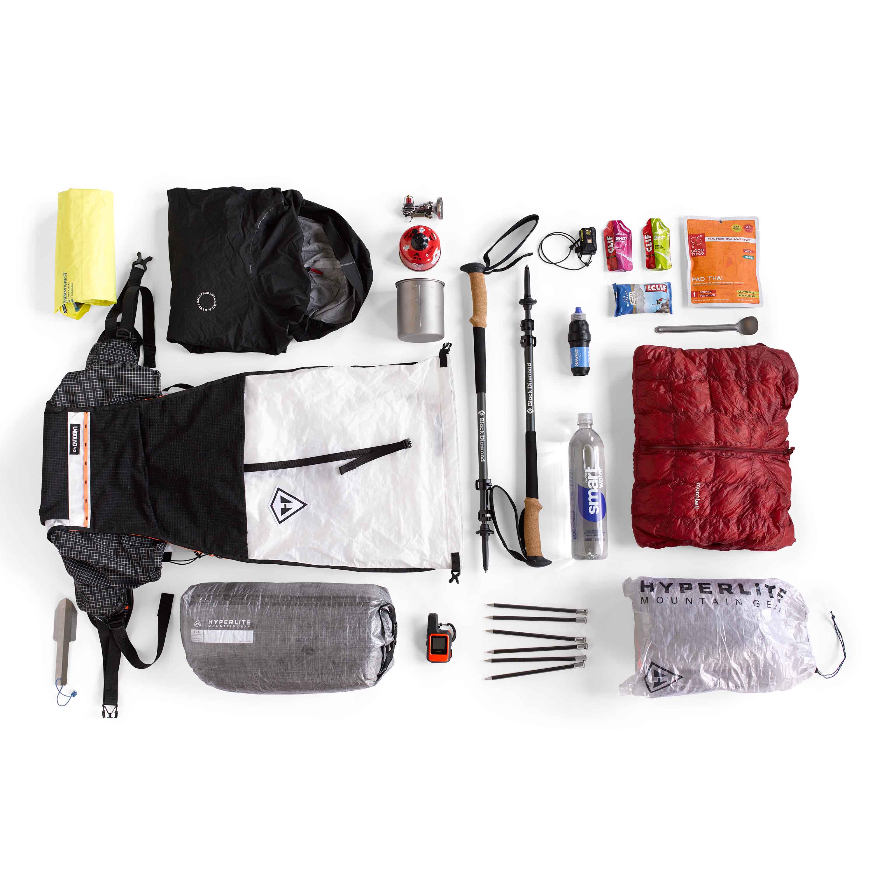 Hyperlite Mountain Gear Unbound 40 in white unpacked with all the essentail gear for a trip laid out beside it