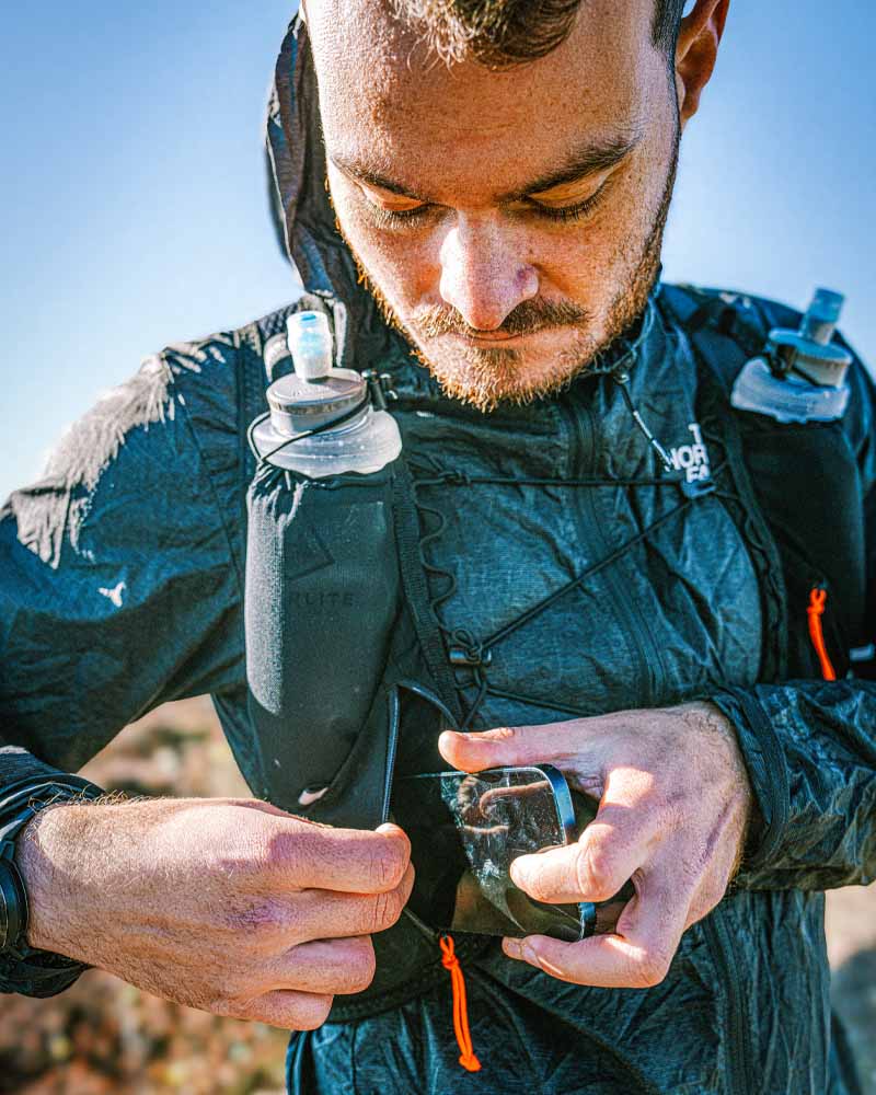 Max in the Pemi 15 stashing his phone away on a sunny day