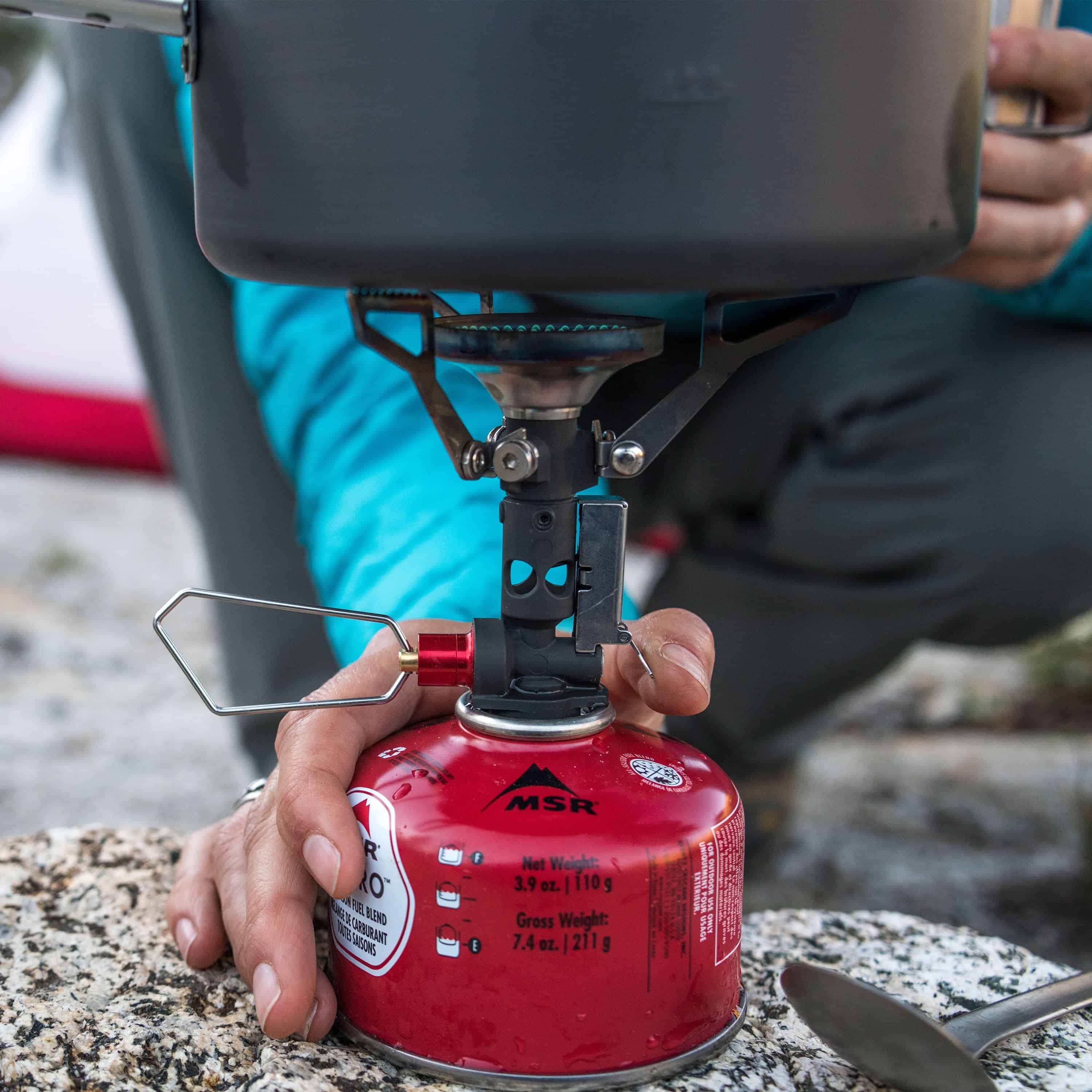 Detail shot of Hyperlite Mountain Gear's MSR PocketRocket® Deluxe push-start ignition in use