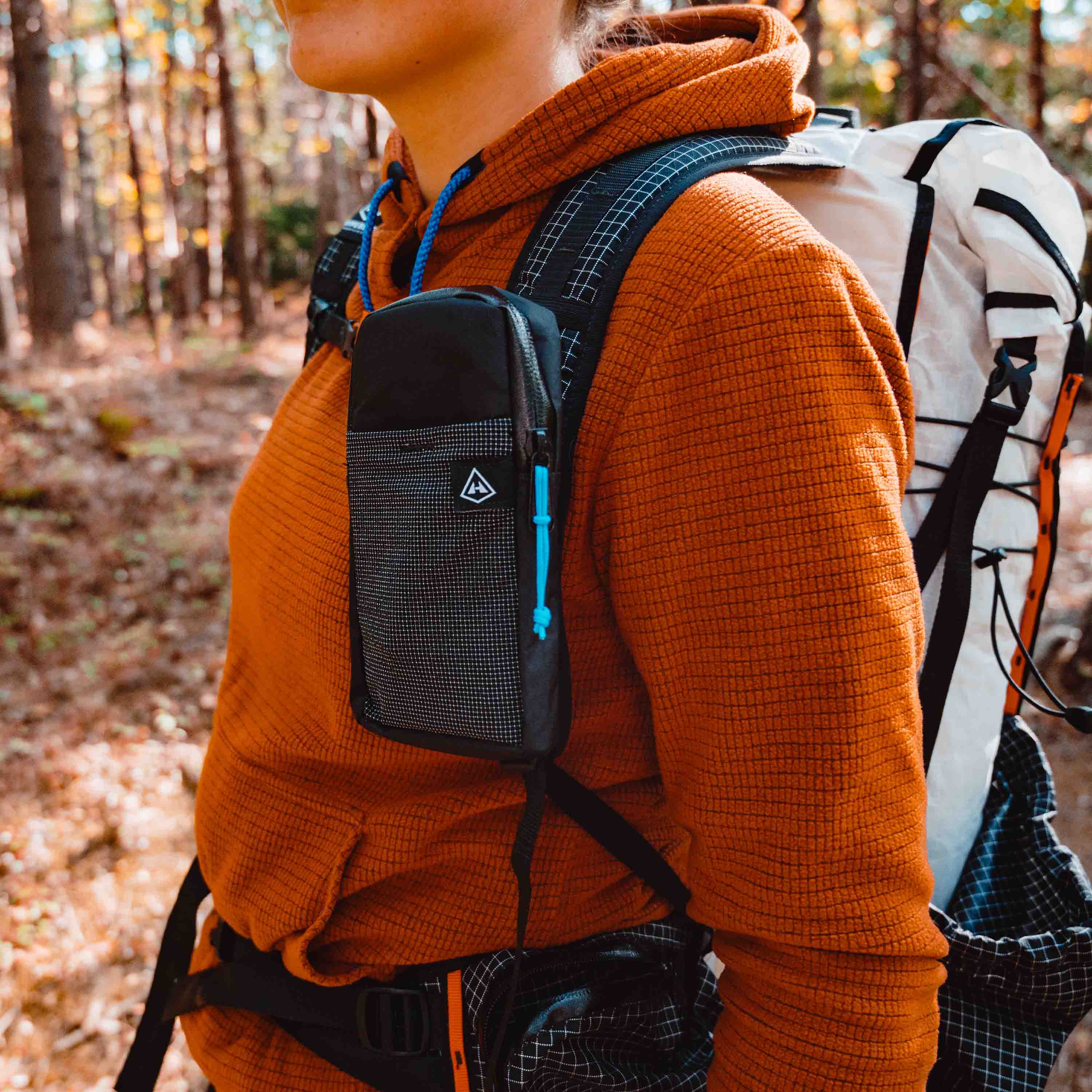 Left side view of Hyperlite Mountain Gear's Shoulder Pocket in Black on hiker