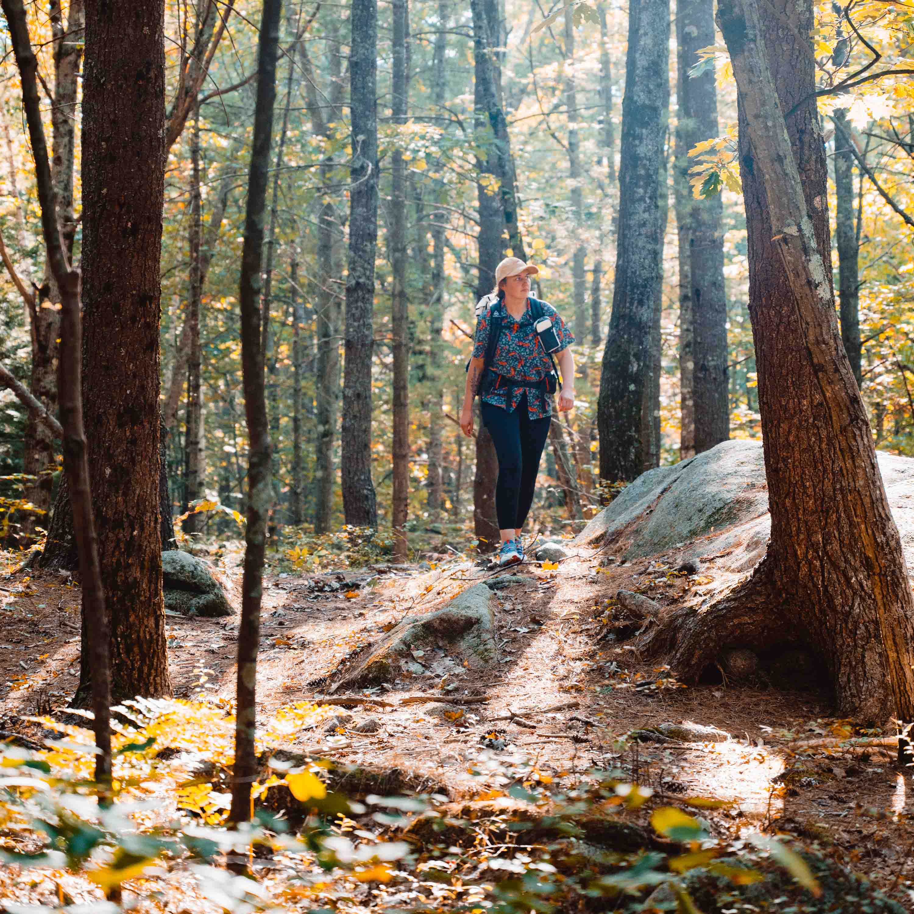 Front view of Hyperlite Mountain Gear's Shoulder Pocket in White on hiker in woods