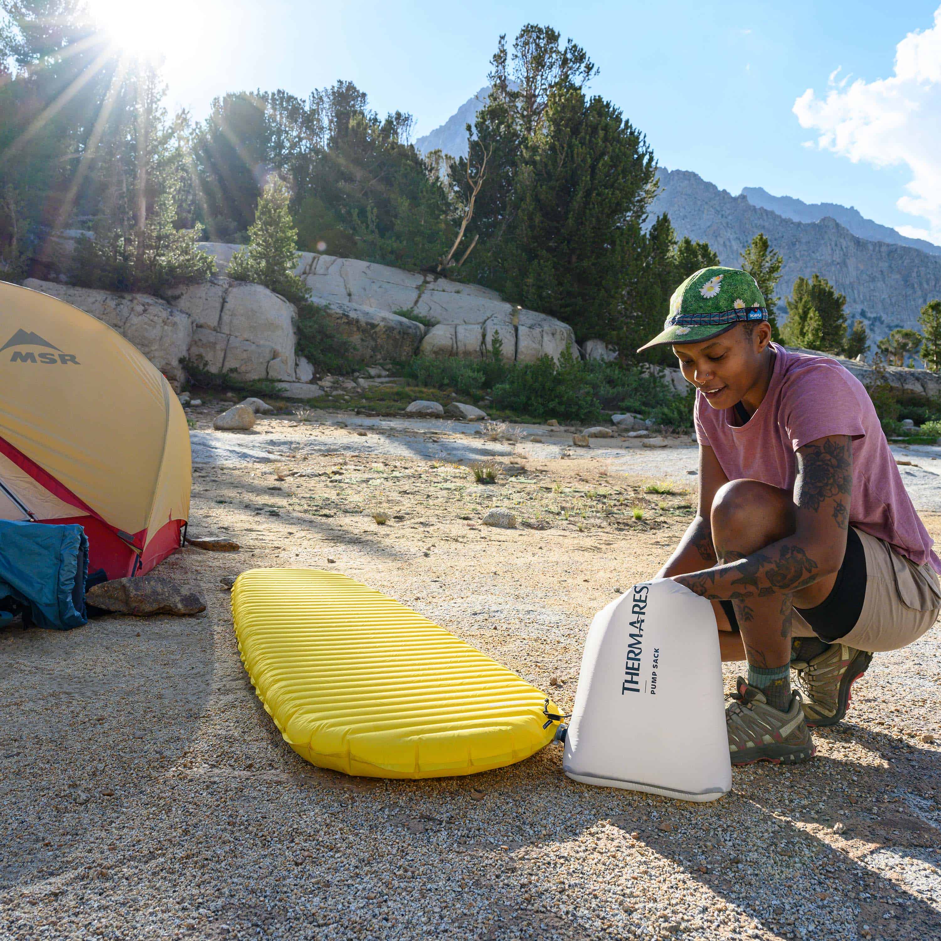 Camper pumping up Hyperlite Mountain Gear's Therm-a-Rest NeoAir® XLite™ NXT Sleeping Pad with Therm-a-Rest Pump Sack