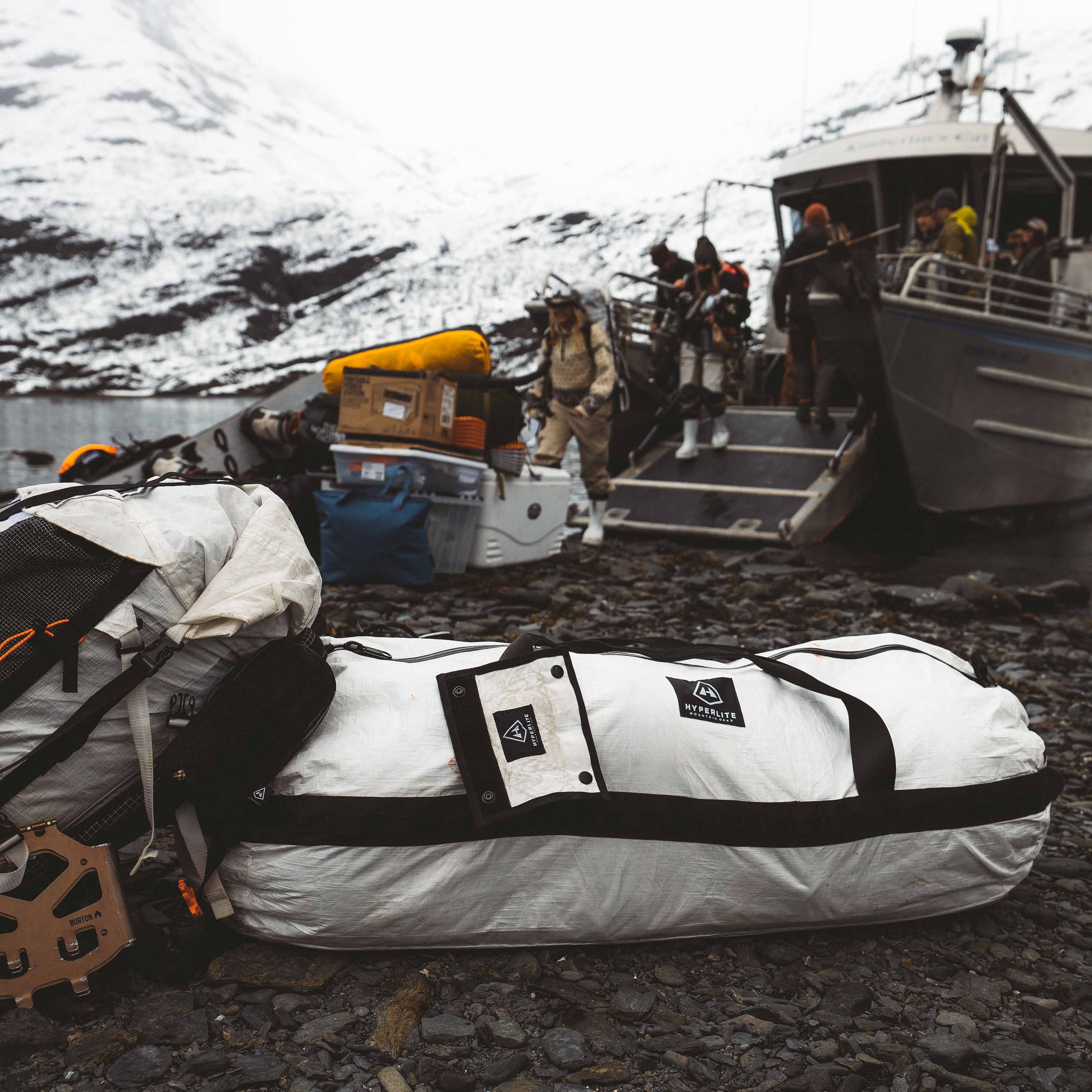 A fully packed Hyperlite Mountain Gear 140L Approach Duffel waiting to be loaded onto a boat