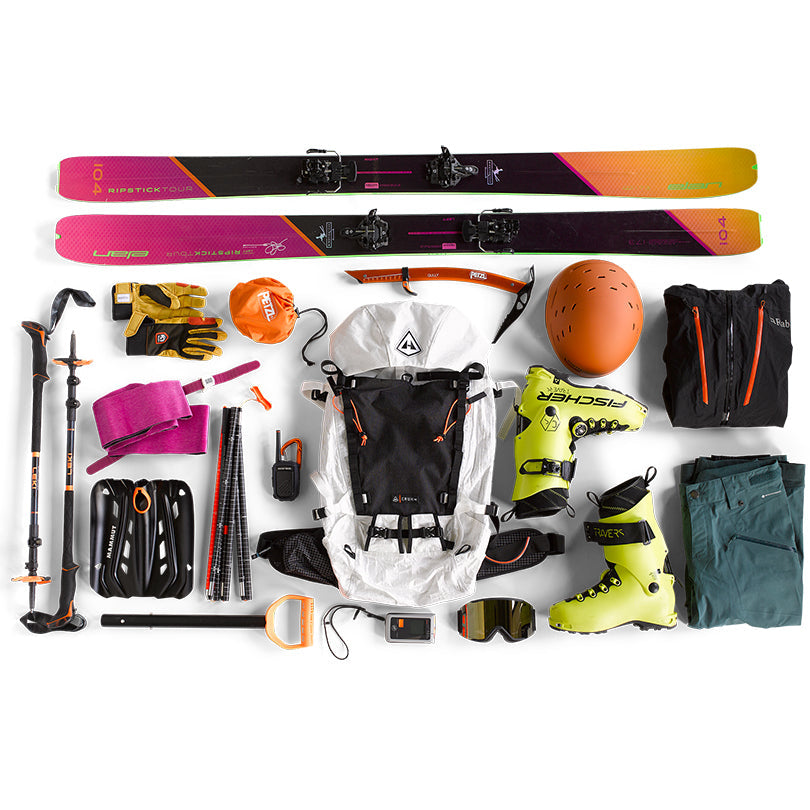 Overhead view of an empty Hyperlite Mountain Gear Crux 40 with all the necessary gear for a trip laid out around it