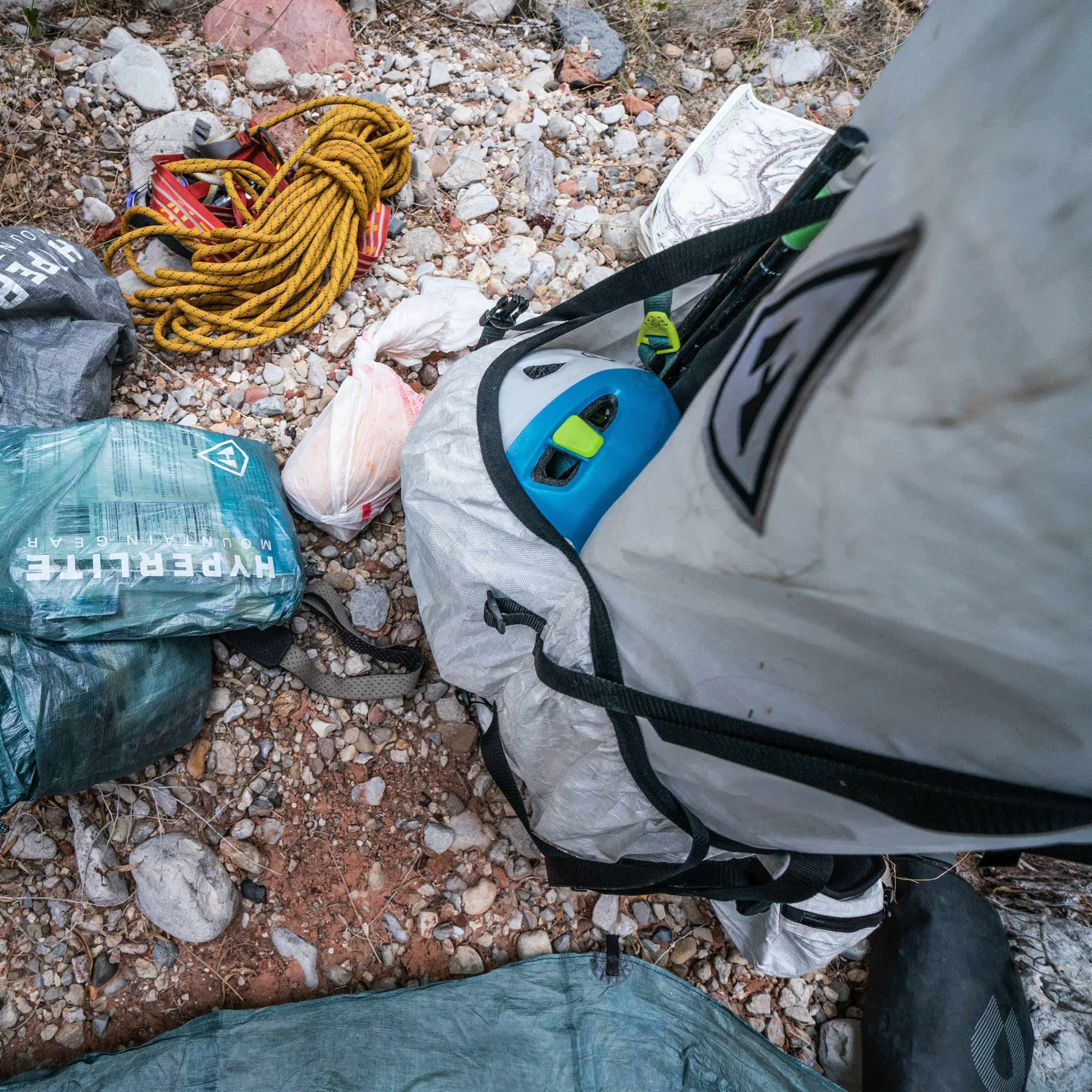 Top view of Hyperlite Mountain Gear's NorthRim 70 Pack in White with helmet in exterior pocket