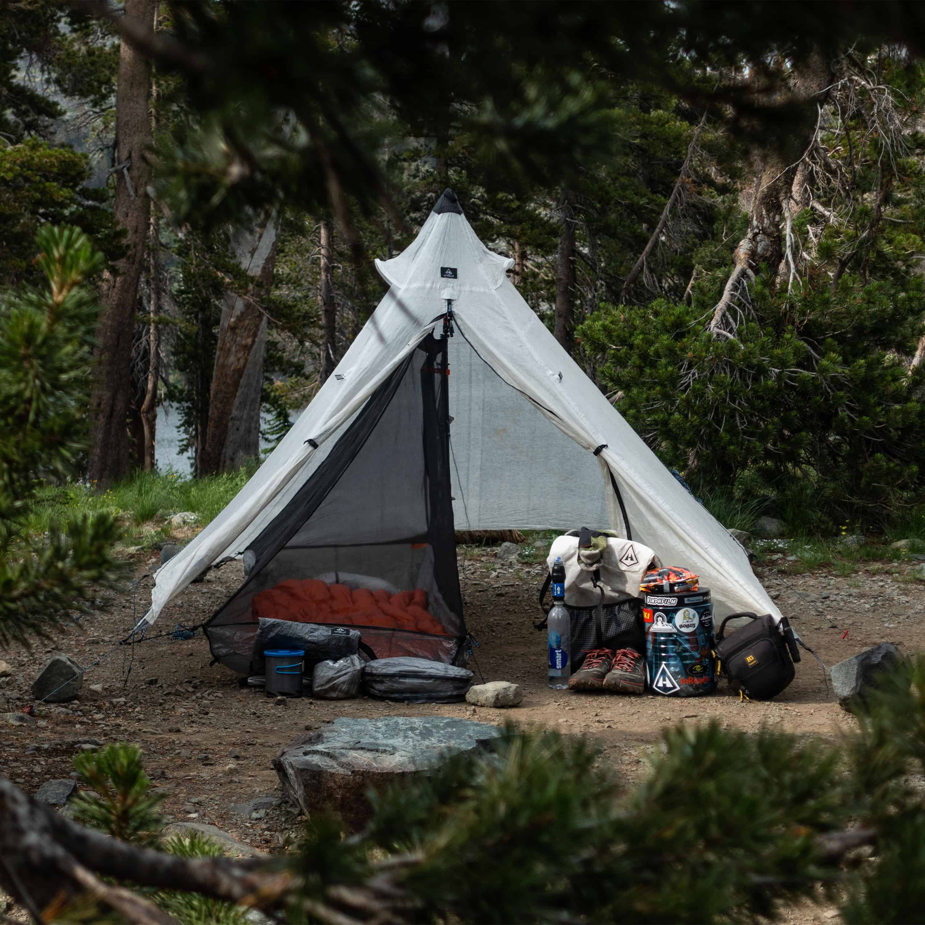 Front exterior view of Hyperlite Mountain Gear Shelters UltaMid 2 Half Insert inside white tent in a wooded setting