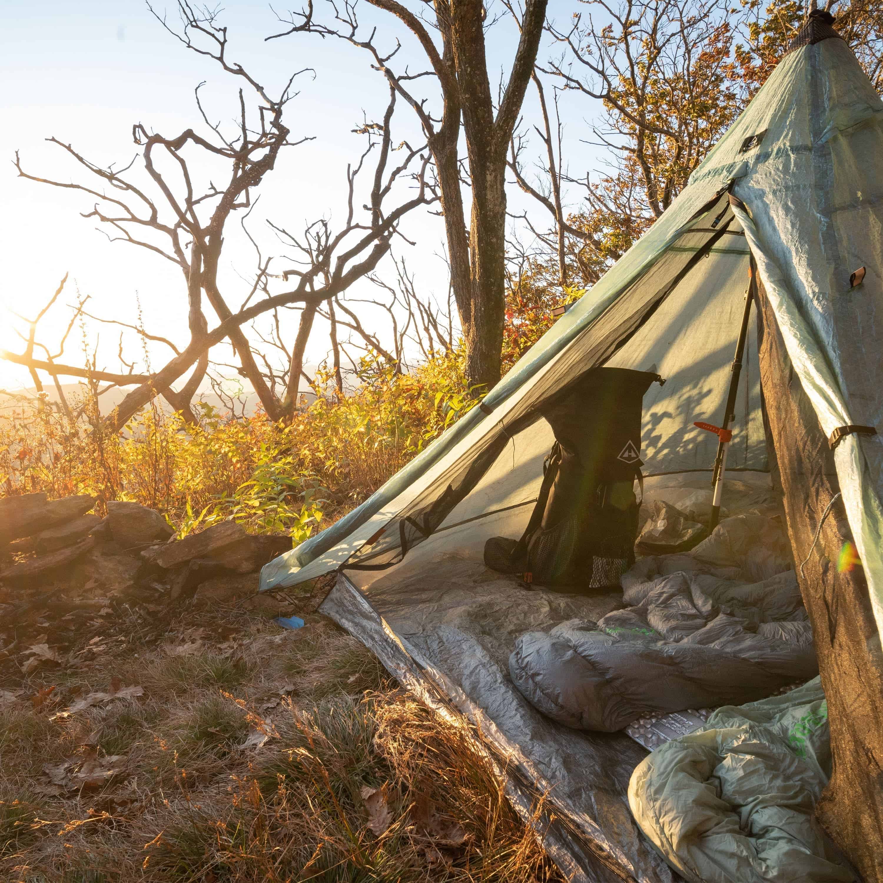 Exterior front view of Hyperlite Mountain Gear Shelters UltaMid 2 Insert with DCF11 Floor inside white tent in a brushy landscape 