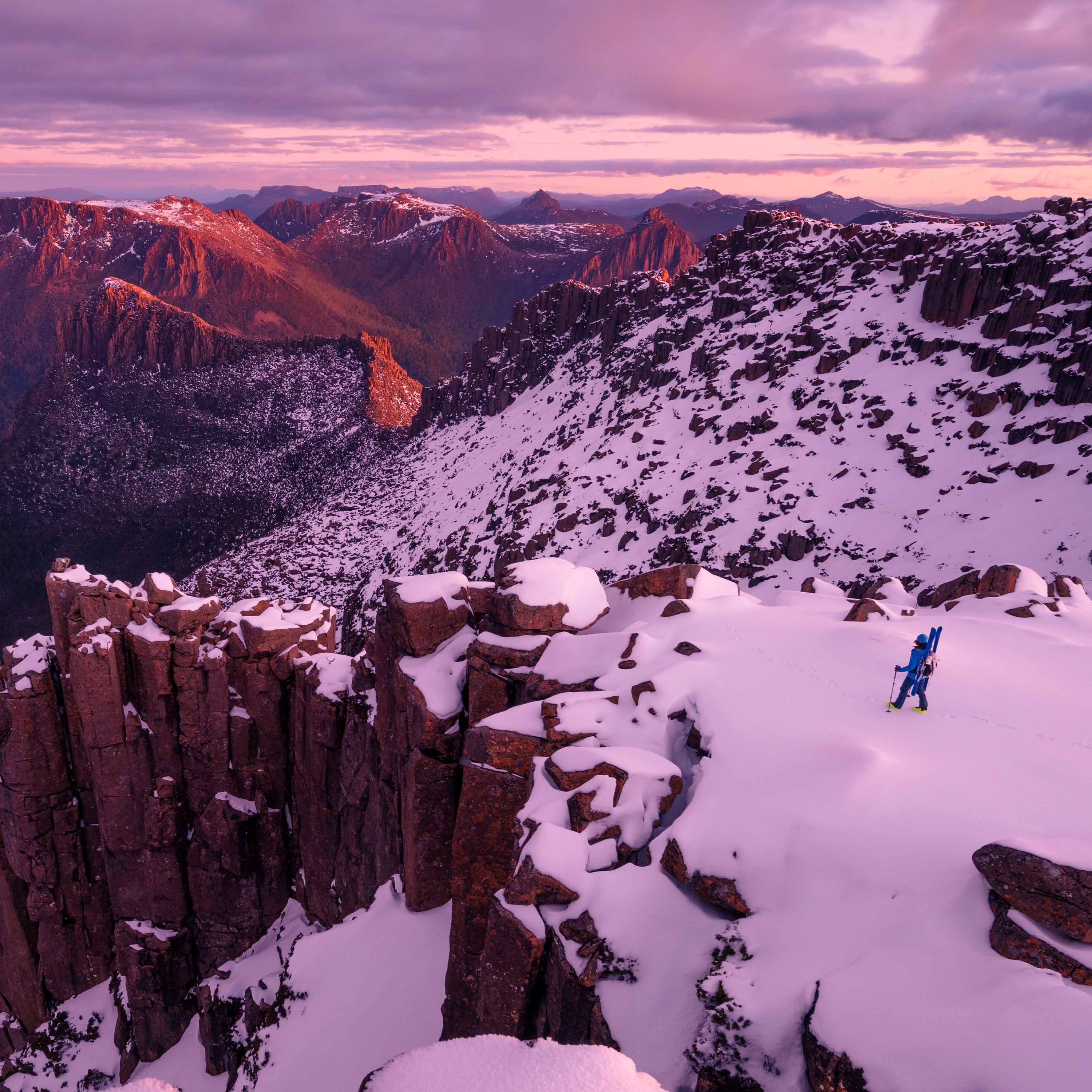 Skiier with the Hyperlite Mountain Gear Headwall 55 on a snowy vista