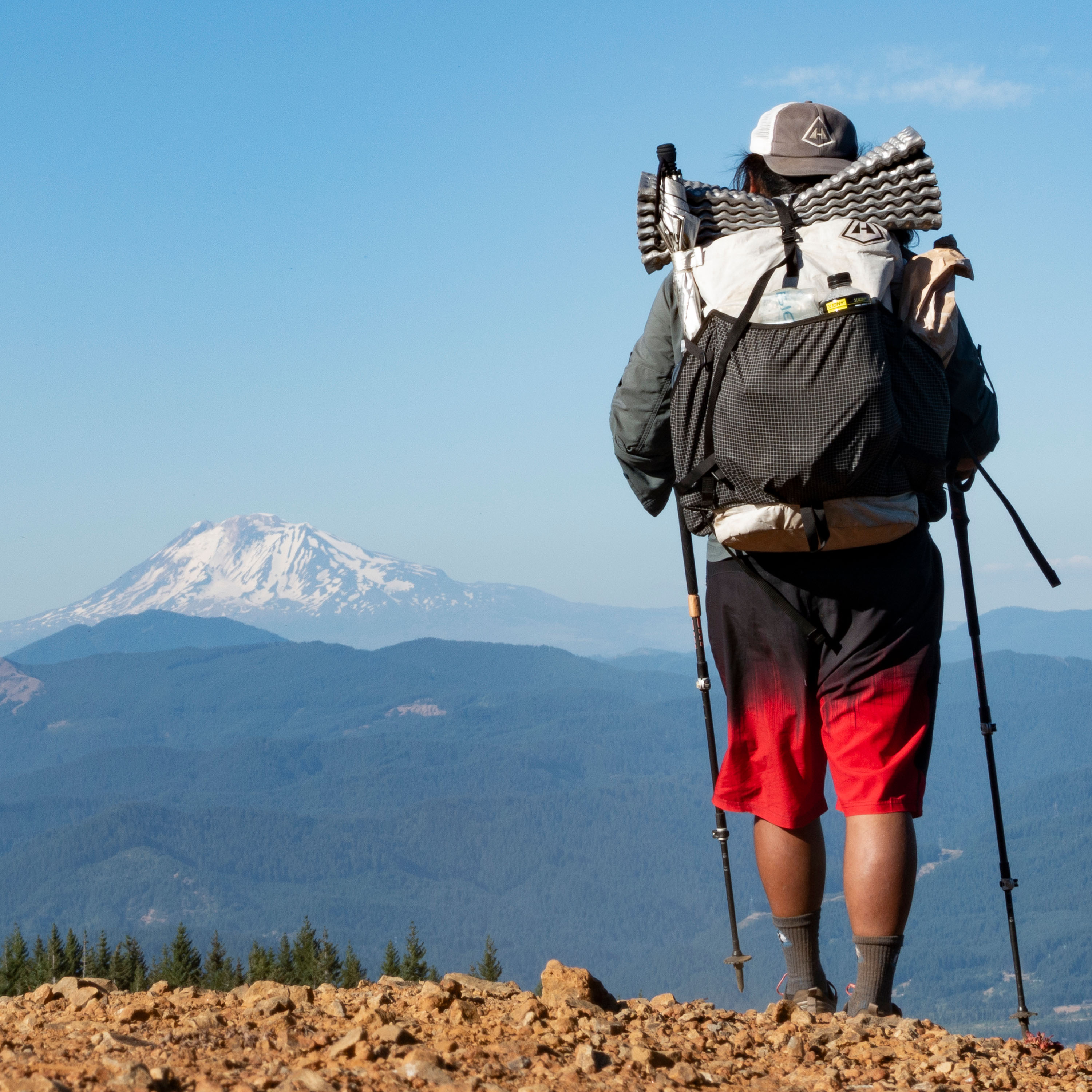 Hyperlite Mountain Gear's Southwest 70 Pack in White on a hikers back in the mountains