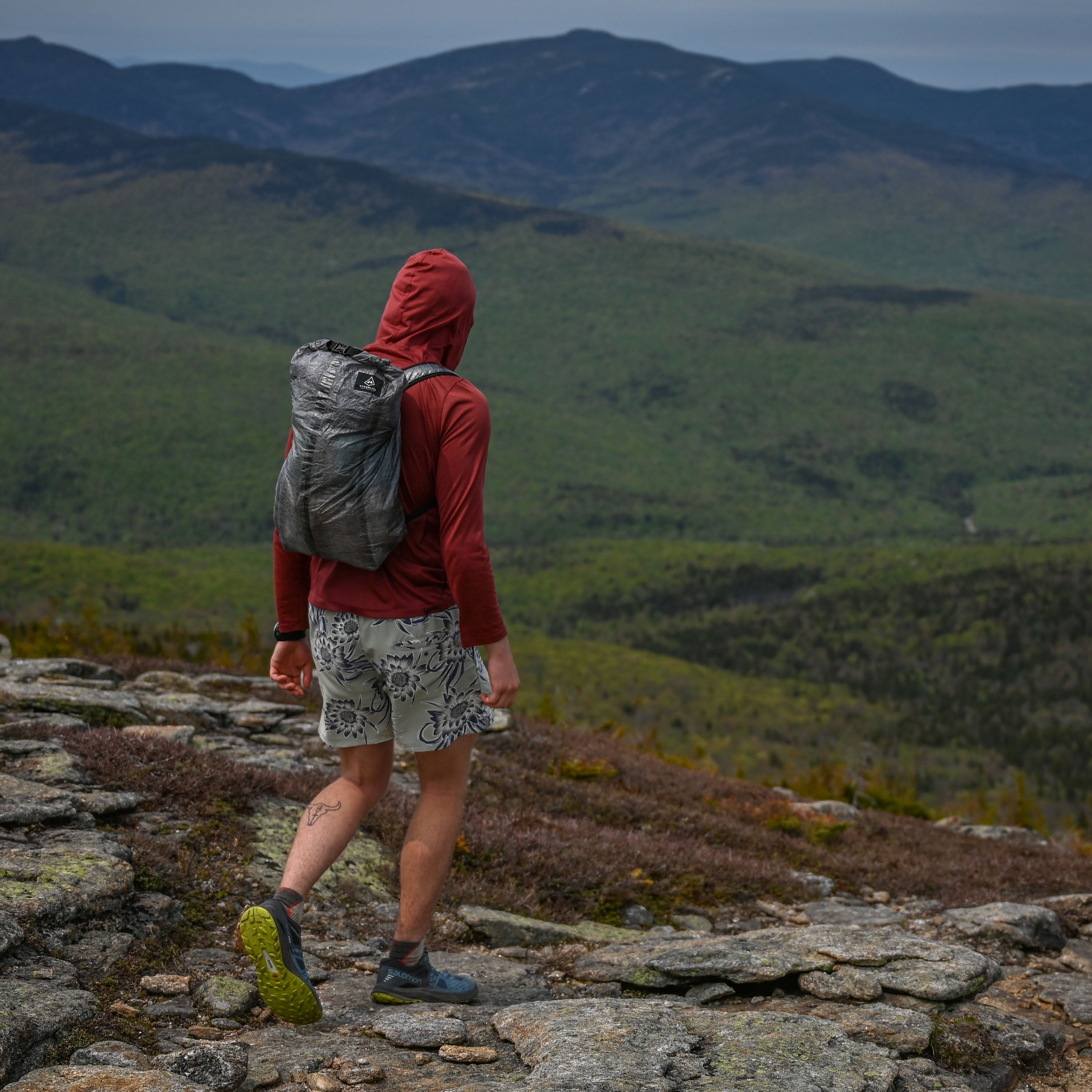 Hiker wearing Hyperlite Mountain Gear's Stuff Pack 30 on mountain top