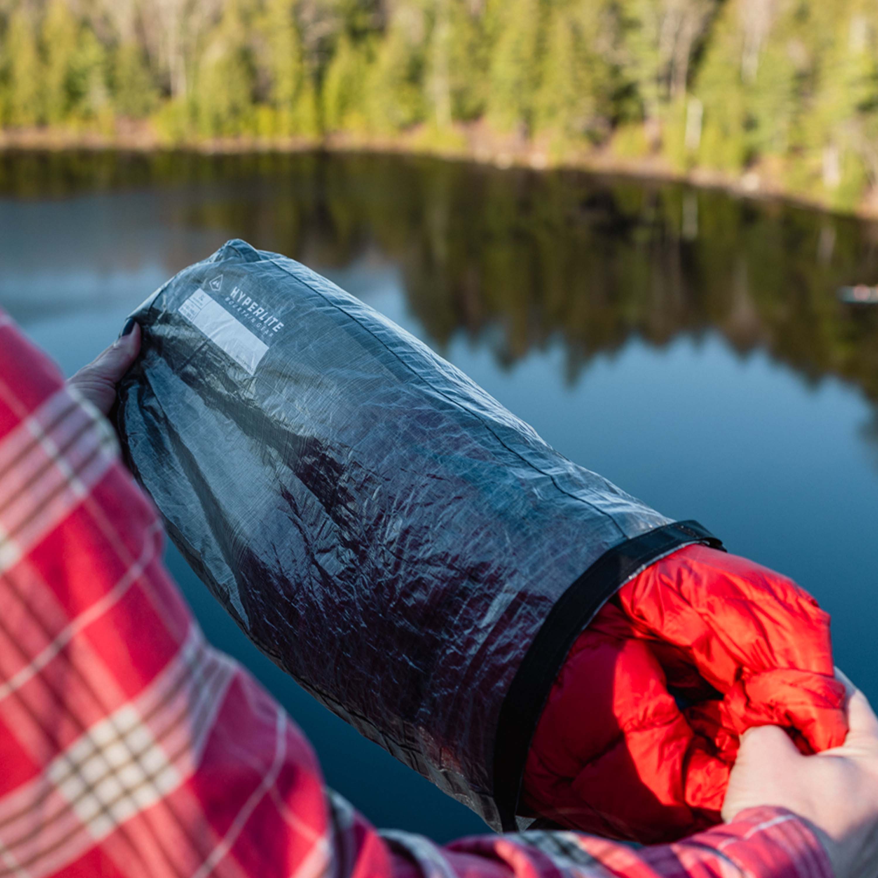 Hiker removing their clothing from Hyperlite Mountain Gear's 8L Side Entry Pod