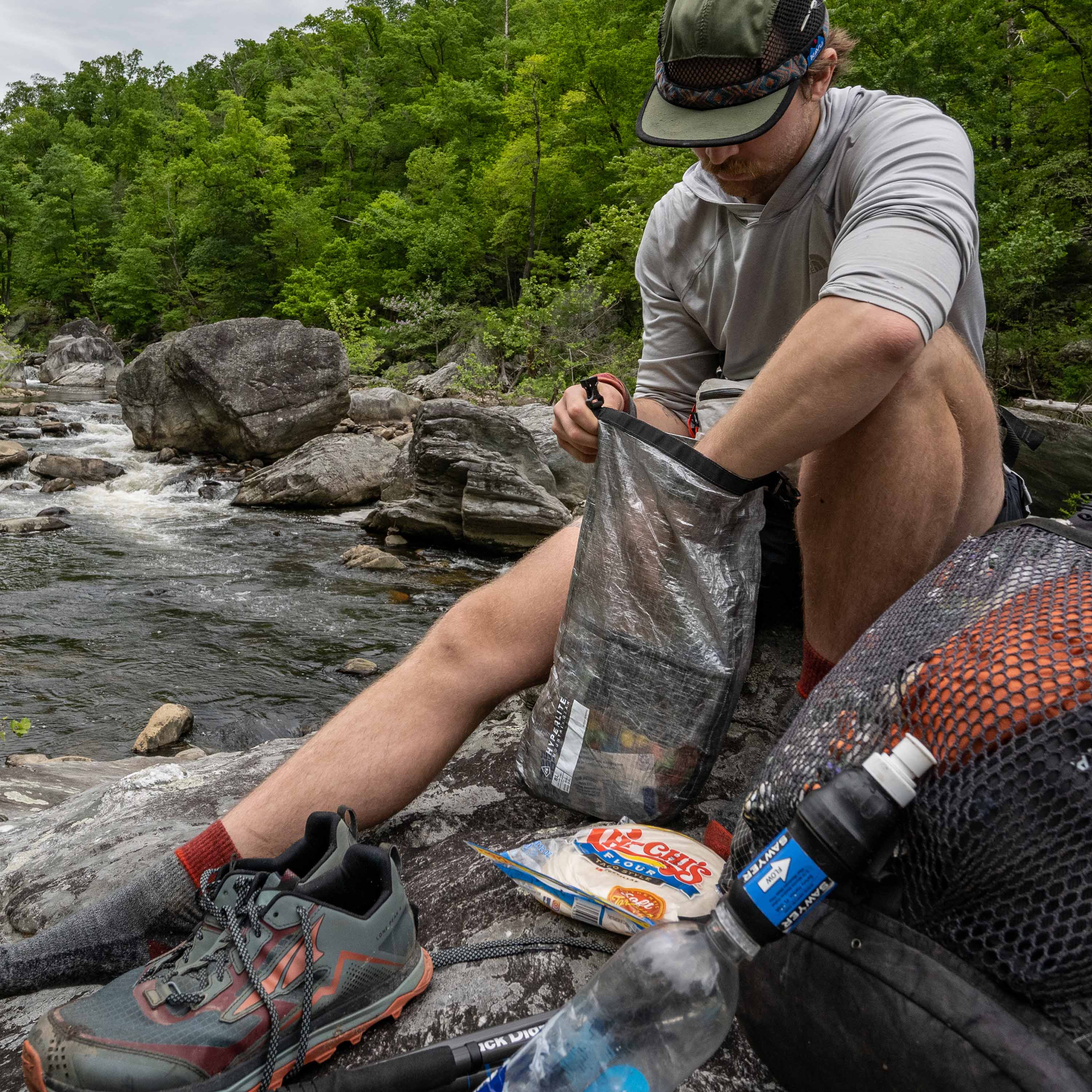 Hiker removing food and supplies from Hyperlite Mountain Gear's 8L Side Entry Pod