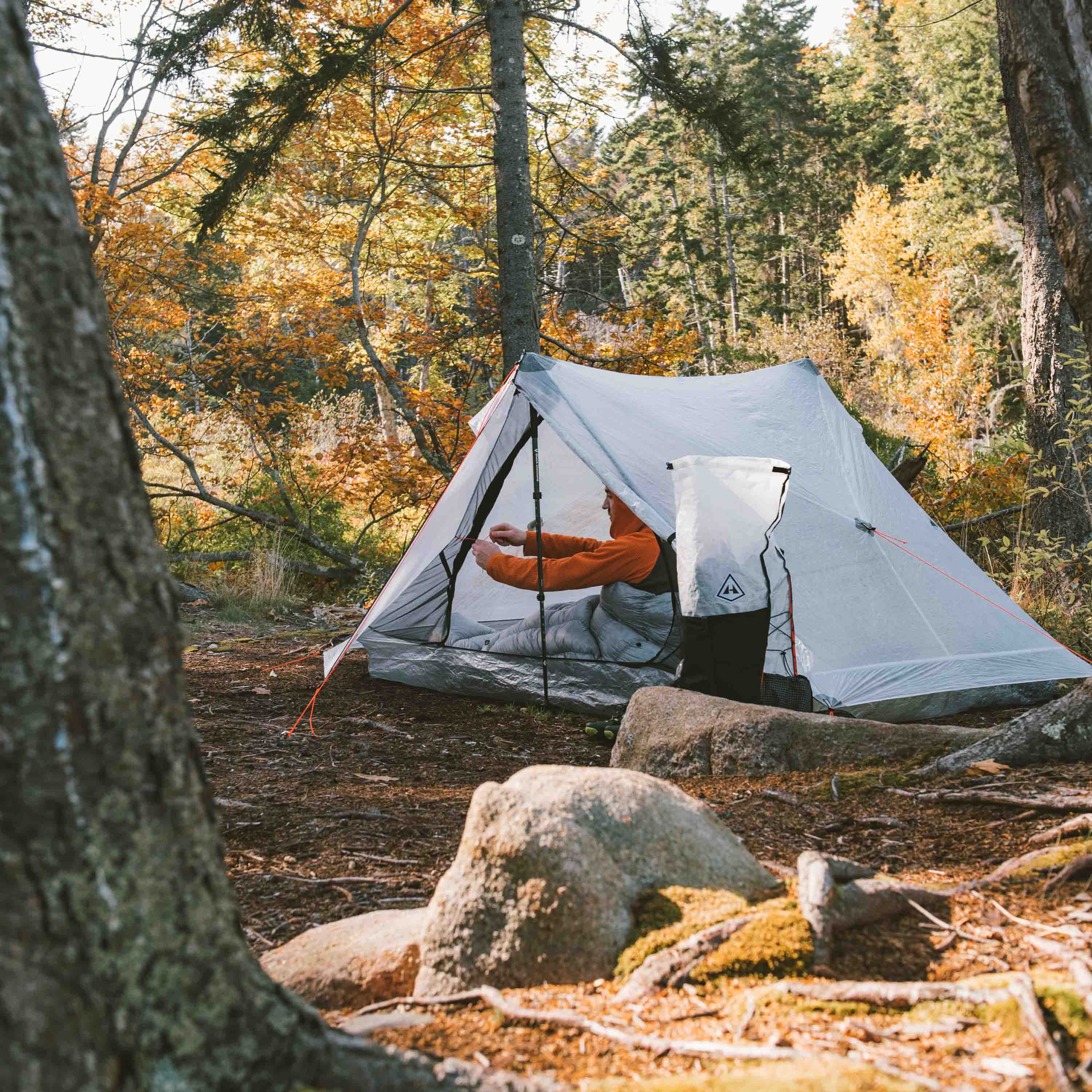 Hiker sets up the Hyperlite Mountain Gear Unbound 2P Tent at camp